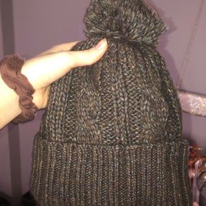 hardly worn beanie with the poof at too